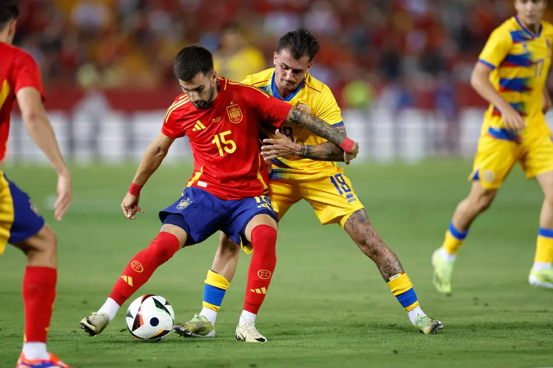 El centrocampista de la selecci&oacute;n espa&ntilde;ola de f&uacute;tbol &Aacute;lex Baena (i) protege un bal&oacute;n ante el andorrano Jes&uacute;s Rubio, durante el partido amistoso que Espa&ntilde;a y Andorra disputan este mi&eacute;rcoles en el estadio Nuevo Vivero, en Badajoz. EFE/Julio Mu&ntilde;oz