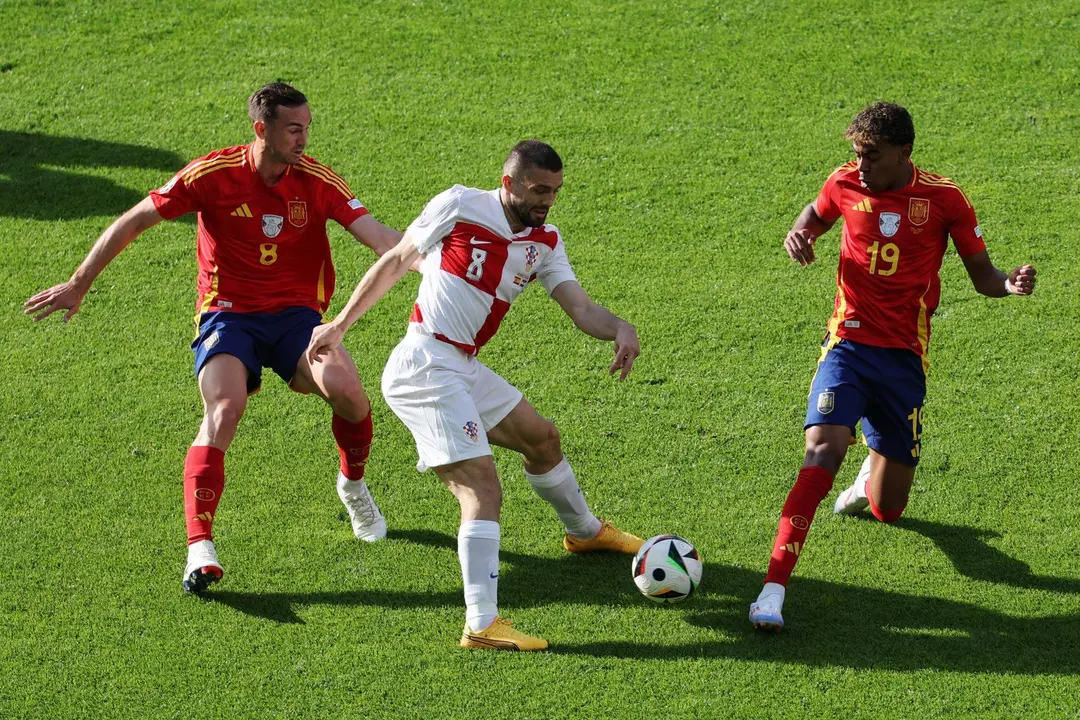 El croata Mateo Kovacic (c) en acci&oacute;n ante Fabian Ruiz (I) y Lamine Yamal en el partido del grupo B entre Espa&ntilde;a y Croacia en Berl&iacute;n, Alemania. EFE/EPA/ABEDIN TAHERKENAREH